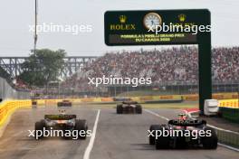 Sergio Perez (MEX) Red Bull Racing RB19 and Lando Norris (GBR) McLaren MCL60 leave the pits. 16.06.2023. Formula 1 World Championship, Rd 9, Canadian Grand Prix, Montreal, Canada, Practice Day.