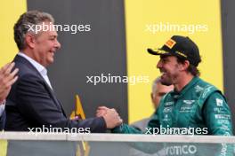 Fernando Alonso (ESP) Aston Martin F1 Team celebrates his second position with Mario Isola (ITA) Pirelli Racing Manager on the podium. 18.06.2023. Formula 1 World Championship, Rd 9, Canadian Grand Prix, Montreal, Canada, Race Day.