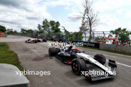 Nyck de Vries (NLD) AlphaTauri AT04 and Kevin Magnussen (DEN) Haas VF-23 run on at the exit road and reverse back on to the circuit. 18.06.2023. Formula 1 World Championship, Rd 9, Canadian Grand Prix, Montreal, Canada, Race Day.