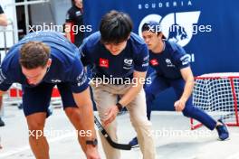 Yuki Tsunoda (JPN) AlphaTauri and Nyck de Vries (NLD) AlphaTauri play hockey in the pits. 15.06.2023. Formula 1 World Championship, Rd 9, Canadian Grand Prix, Montreal, Canada, Preparation Day.