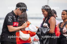 Zhou Guanyu (CHN) Alfa Romeo F1 Team with fans in the pits. 15.06.2023. Formula 1 World Championship, Rd 9, Canadian Grand Prix, Montreal, Canada, Preparation Day.