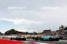 George Russell (GBR) Mercedes AMG F1 W14 and Lance Stroll (CDN) Aston Martin F1 Team AMR23. 04.06.2023. Formula 1 World Championship, Rd 8, Spanish Grand Prix, Barcelona, Spain, Race Day.