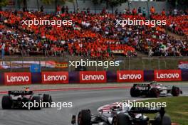 Nico Hulkenberg (GER) Haas VF-23 leads Sergio Perez (MEX) Red Bull Racing RB19. 04.06.2023. Formula 1 World Championship, Rd 8, Spanish Grand Prix, Barcelona, Spain, Race Day.
