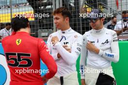 (L to R): Carlos Sainz Jr (ESP) Ferrari with Alexander Albon (THA) Williams Racing and Esteban Ocon (FRA) Alpine F1 Team on the grid. 09.07.2023. Formula 1 World Championship, Rd 11, British Grand Prix, Silverstone, England, Race Day.