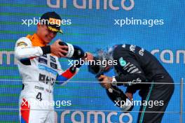 (L to R): Lando Norris (GBR) McLaren celebrates his second position on the podium with Lewis Hamilton (GBR) Mercedes AMG F1. 09.07.2023. Formula 1 World Championship, Rd 11, British Grand Prix, Silverstone, England, Race Day.