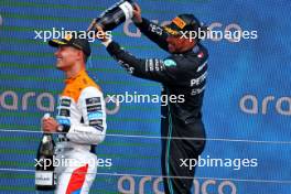 (L to R): Lando Norris (GBR) McLaren celebrates his second position on the podium with Lewis Hamilton (GBR) Mercedes AMG F1. 09.07.2023. Formula 1 World Championship, Rd 11, British Grand Prix, Silverstone, England, Race Day.