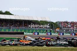 Lando Norris (GBR) McLaren MCL60 and Lewis Hamilton (GBR) Mercedes AMG F1 W14 battle for position. 09.07.2023. Formula 1 World Championship, Rd 11, British Grand Prix, Silverstone, England, Race Day.