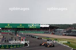 Max Verstappen (NLD) Red Bull Racing RB19 and Oscar Piastri (AUS) McLaren MCL60 battle for position at the start of the race. 09.07.2023. Formula 1 World Championship, Rd 11, British Grand Prix, Silverstone, England, Race Day.