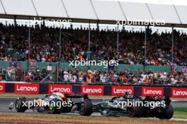 Lando Norris (GBR) McLaren MCL60 and Lewis Hamilton (GBR) Mercedes AMG F1 W14 battle for position. 09.07.2023. Formula 1 World Championship, Rd 11, British Grand Prix, Silverstone, England, Race Day.