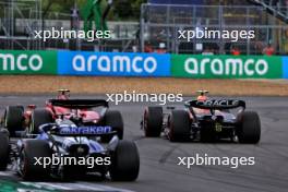 Carlos Sainz Jr (ESP) Ferrari SF-23 and Sergio Perez (MEX) Red Bull Racing RB19 battle for position. 09.07.2023. Formula 1 World Championship, Rd 11, British Grand Prix, Silverstone, England, Race Day.