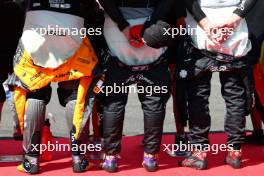 (L to R): Lando Norris (GBR) McLaren; Zhou Guanyu (CHN) Alfa Romeo F1 Team; and Valtteri Bottas (FIN) Alfa Romeo F1 Team, as the grid observes the national anthem. 23.07.2023. Formula 1 World Championship, Rd 12, Hungarian Grand Prix, Budapest, Hungary, Race Day.