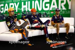 (L to R): Lando Norris (GBR) McLaren; Max Verstappen (NLD) Red Bull Racing; and Sergio Perez (MEX) Red Bull Racing, in the post race FIA Press Conference. 23.07.2023. Formula 1 World Championship, Rd 12, Hungarian Grand Prix, Budapest, Hungary, Race Day.