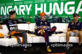 (L to R): Lando Norris (GBR) McLaren; Max Verstappen (NLD) Red Bull Racing; and Sergio Perez (MEX) Red Bull Racing, in the post race FIA Press Conference. 23.07.2023. Formula 1 World Championship, Rd 12, Hungarian Grand Prix, Budapest, Hungary, Race Day.