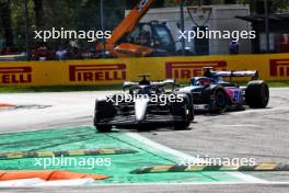 George Russell (GBR) Mercedes AMG F1 W14 leaves the pits ahead of Esteban Ocon (FRA) Alpine F1 Team A523 and runs wide. 03.09.2023. Formula 1 World Championship, Rd 15, Italian Grand Prix, Monza, Italy, Race Day.