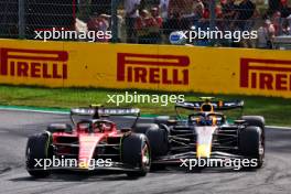 Carlos Sainz Jr (ESP) Ferrari SF-23 and Sergio Perez (MEX) Red Bull Racing RB19 battle for position. 03.09.2023. Formula 1 World Championship, Rd 15, Italian Grand Prix, Monza, Italy, Race Day.
