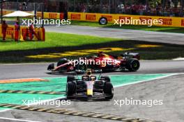 Carlos Sainz Jr (ESP) Ferrari SF-23 and Sergio Perez (MEX) Red Bull Racing RB19 battle for position. 03.09.2023. Formula 1 World Championship, Rd 15, Italian Grand Prix, Monza, Italy, Race Day.