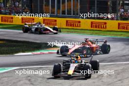 Carlos Sainz Jr (ESP) Ferrari SF-23 and Sergio Perez (MEX) Red Bull Racing RB19 battle for position. 03.09.2023. Formula 1 World Championship, Rd 15, Italian Grand Prix, Monza, Italy, Race Day.