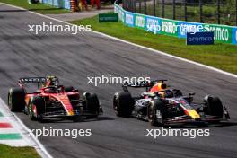 Max Verstappen (NLD) Red Bull Racing RB19 and Carlos Sainz Jr (ESP) Ferrari SF-23 battle for position. 03.09.2023. Formula 1 World Championship, Rd 15, Italian Grand Prix, Monza, Italy, Race Day.