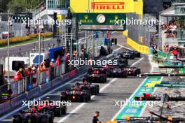 Carlos Sainz Jr (ESP) Ferrari SF-23 and Sergio Perez (MEX) Red Bull Racing RB19 leave the pits. 02.09.2023. Formula 1 World Championship, Rd 15, Italian Grand Prix, Monza, Italy, Qualifying Day.