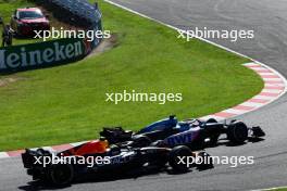 (L to R): Sergio Perez (MEX) Red Bull Racing RB19 and Esteban Ocon (FRA) Alpine F1 Team A523 battle for position. 24.09.2023. Formula 1 World Championship, Rd 17, Japanese Grand Prix, Suzuka, Japan, Race Day.