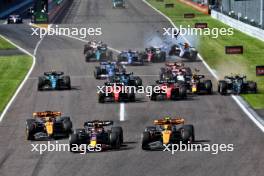 (L to R): Max Verstappen (NLD) Red Bull Racing RB19 and Lando Norris (GBR) McLaren MCL60 lead at the start of the race. Lewis Hamilton (GBR) Mercedes AMG F1 W14 runs wide and Alexander Albon (THA) Williams Racing FW45 airborne. 24.09.2023. Formula 1 World Championship, Rd 17, Japanese Grand Prix, Suzuka, Japan, Race Day.