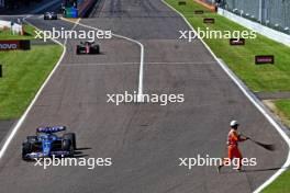 Marshal on track as Esteban Ocon (FRA) Alpine F1 Team A523 leaves the pits. 24.09.2023. Formula 1 World Championship, Rd 17, Japanese Grand Prix, Suzuka, Japan, Race Day.