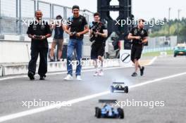Esteban Ocon (FRA), Alpine F1 Team and Lewis Hamilton (GBR), Mercedes AMG F1  race with RC cars 21.09.2023. Formula 1 World Championship, Rd 17, Japanese Grand Prix, Suzuka, Japan, Preparation Day.