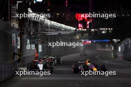 Daniel Ricciardo (AUS) AlphaTauri AT04 and Sergio Perez (MEX) Red Bull Racing RB19 battle for position. 18.11.2023. Formula 1 World Championship, Rd 22, Las Vegas Grand Prix, Las Vegas, Nevada, USA, Race Day.