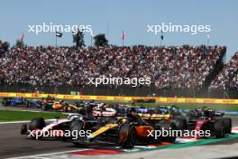 Oscar Piastri (AUS) McLaren MCL60 and Nico Hulkenberg (GER) Haas VF-23 at the start of the race. 29.10.2023. Formula 1 World Championship, Rd 20, Mexican Grand Prix, Mexico City, Mexico, Race Day.