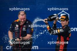(L to R): Oliver Hughes (GBR) Red Bull Racing Chief Marketing Officer celebrates on the podium with Sergio Perez (MEX) Red Bull Racing. 07.05.2023. Formula 1 World Championship, Rd 5, Miami Grand Prix, Miami, Florida, USA, Race Day.
