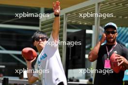 Zhou Guanyu (CHN) Alfa Romeo F1 Team with Miami Dolphins American Football Player. 04.05.2023. Formula 1 World Championship, Rd 5, Miami Grand Prix, Miami, Florida, USA, Preparation Day.