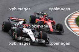 Yuki Tsunoda (JPN) AlphaTauri AT04 and Carlos Sainz Jr (ESP) Ferrari SF-23 battle for position. 27.08.2023. Formula 1 World Championship, Rd 14, Dutch Grand Prix, Zandvoort, Netherlands, Race Day.