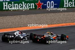 Liam Lawson (NZL) AlphaTauri AT04 and Lando Norris (GBR) McLaren MCL60 battle for position. 27.08.2023. Formula 1 World Championship, Rd 14, Dutch Grand Prix, Zandvoort, Netherlands, Race Day.
