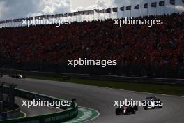 Zhou Guanyu (CHN) Alfa Romeo F1 Team C43 and Esteban Ocon (FRA) Alpine F1 Team A523 battle for position. 27.08.2023. Formula 1 World Championship, Rd 14, Dutch Grand Prix, Zandvoort, Netherlands, Race Day.