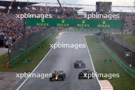 Sergio Perez (MEX) Red Bull Racing RB19 and Lewis Hamilton (GBR) Mercedes AMG F1 W14 battle for position. 27.08.2023. Formula 1 World Championship, Rd 14, Dutch Grand Prix, Zandvoort, Netherlands, Race Day.