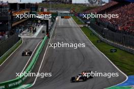 Max Verstappen (NLD) Red Bull Racing RB19 leads Sergio Perez (MEX) Red Bull Racing RB19 who leaves the pits. 27.08.2023. Formula 1 World Championship, Rd 14, Dutch Grand Prix, Zandvoort, Netherlands, Race Day.