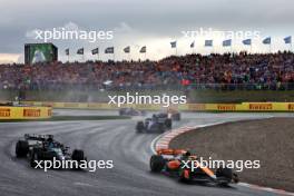 Lando Norris (GBR) McLaren MCL60 and George Russell (GBR) Mercedes AMG F1 W14 battle for position. 27.08.2023. Formula 1 World Championship, Rd 14, Dutch Grand Prix, Zandvoort, Netherlands, Race Day.