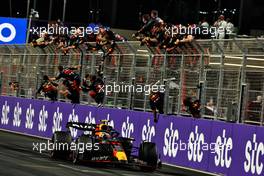 Race winner Sergio Perez (MEX) Red Bull Racing RB19 celebrates as he passes the team at the end of the race. 19.03.2023. Formula 1 World Championship, Rd 2, Saudi Arabian Grand Prix, Jeddah, Saudi Arabia, Race Day.