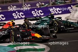 Sergio Perez (MEX) Red Bull Racing RB19 and Fernando Alonso (ESP) Aston Martin F1 Team AMR23 battle for the lead of the race. 19.03.2023. Formula 1 World Championship, Rd 2, Saudi Arabian Grand Prix, Jeddah, Saudi Arabia, Race Day.