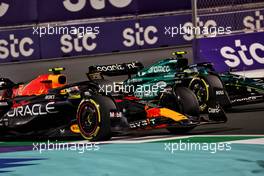 Sergio Perez (MEX) Red Bull Racing RB19 and Fernando Alonso (ESP) Aston Martin F1 Team AMR23 battle for the lead of the race. 19.03.2023. Formula 1 World Championship, Rd 2, Saudi Arabian Grand Prix, Jeddah, Saudi Arabia, Race Day.