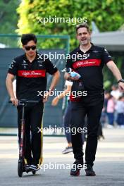 (L to R): Zhou Guanyu (CHN) Alfa Romeo F1 Team with Will Ponissi (ITA) Alfa Romeo F1 Team Senior Communications Manager. 17.09.2023. Formula 1 World Championship, Rd 16, Singapore Grand Prix, Marina Bay Street Circuit, Singapore, Race Day.