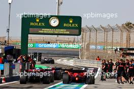 Lewis Hamilton (GBR) Mercedes AMG F1 W14 and Carlos Sainz Jr (ESP) Ferrari SF-23 in the pits. 24.02.2023. Formula 1 Testing, Sakhir, Bahrain, Day Two.