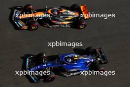 Logan Sargeant (USA) Williams Racing FW45 and Oscar Piastri (AUS) McLaren MCL60. 24.11.2023. Formula 1 World Championship, Rd 23, Abu Dhabi Grand Prix, Yas Marina Circuit, Abu Dhabi, Practice Day.