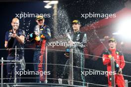 Race winner Max Verstappen (NLD) Red Bull Racing celebrates on the podium with George Russell (GBR) Mercedes AMG F1 and Charles Leclerc (MON) Ferrari. 26.11.2023. Formula 1 World Championship, Rd 23, Abu Dhabi Grand Prix, Yas Marina Circuit, Abu Dhabi, Race Day.