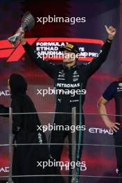 George Russell (GBR) Mercedes AMG F1 celebrates his third position on the podium. 26.11.2023. Formula 1 World Championship, Rd 23, Abu Dhabi Grand Prix, Yas Marina Circuit, Abu Dhabi, Race Day.