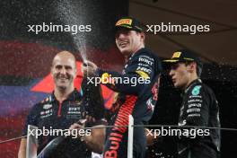 Race winner Max Verstappen (NLD) Red Bull Racing celebrates on the podium with Jamie Meades (GBR) Red Bull Racing Head Of Supply Chain Operations and George Russell (GBR) Mercedes AMG F1 on the podium. 26.11.2023. Formula 1 World Championship, Rd 23, Abu Dhabi Grand Prix, Yas Marina Circuit, Abu Dhabi, Race Day.