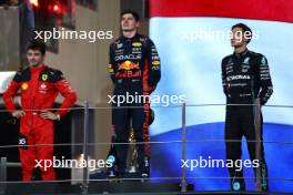 The podium (L to R): Charles Leclerc (MON) Ferrari, second; Max Verstappen (NLD) Red Bull Racing, race winner; George Russell (GBR) Mercedes AMG F1, third. 26.11.2023. Formula 1 World Championship, Rd 23, Abu Dhabi Grand Prix, Yas Marina Circuit, Abu Dhabi, Race Day.