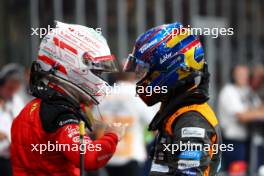 (L to R): Charles Leclerc (MON) Ferrari with Oscar Piastri (AUS) McLaren in qualifying parc ferme. 25.11.2023. Formula 1 World Championship, Rd 23, Abu Dhabi Grand Prix, Yas Marina Circuit, Abu Dhabi, Qualifying Day.