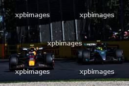 Sergio Perez (MEX) Red Bull Racing RB20 and Lewis Hamilton (GBR) Mercedes AMG F1 W15. 24.03.2024. Formula 1 World Championship, Rd 3, Australian Grand Prix, Albert Park, Melbourne, Australia, Race Day.