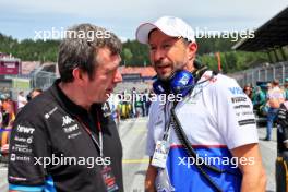 (L to R): Bruno Famin (FRA) Alpine Motorsports Vice President and Alpine F1 Team Team Principal with Peter Bayer (AUT) RB Chief Executive Officer on the grid. 30.06.2024. Formula 1 World Championship, Rd 11, Austrian Grand Prix, Spielberg, Austria, Race Day.